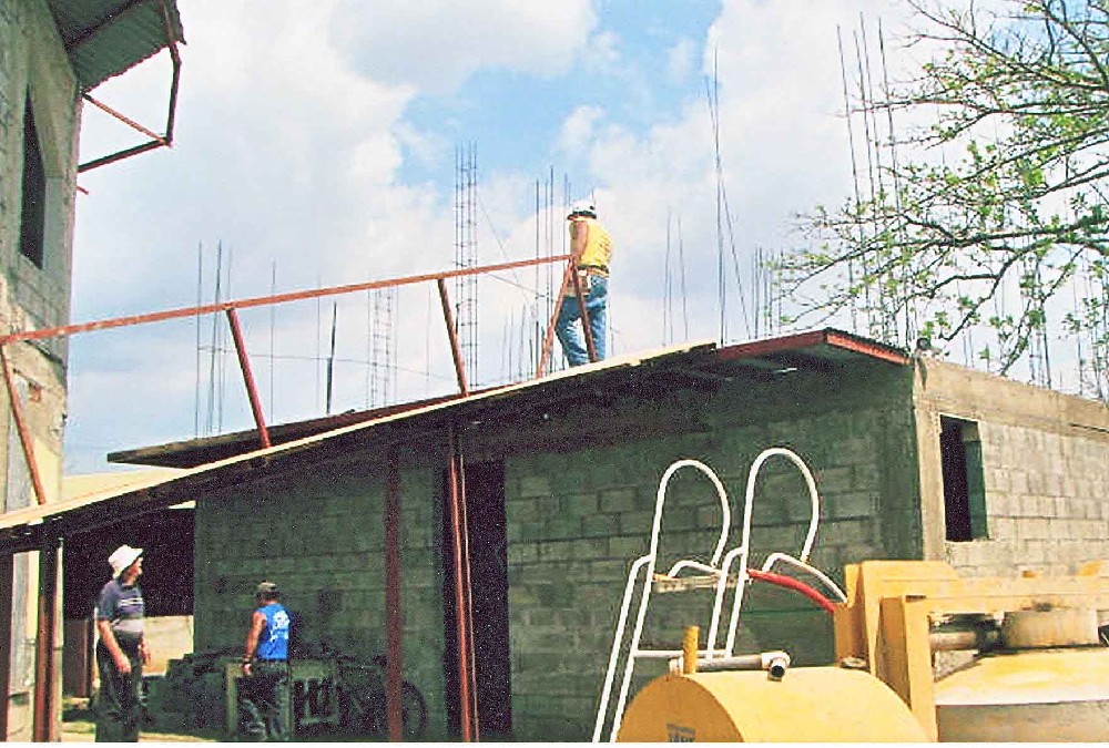 Pouring concrete floor above class rooms